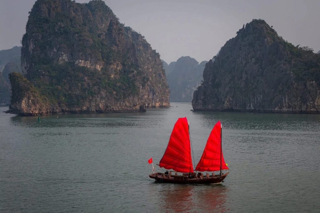 Explore Halong Bay on a Red Sailboat Inspired by Ancient Vietnamese Boats